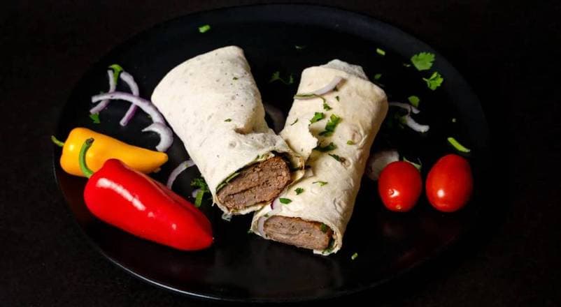 Sliced beef shawarma with charred edges, pickled turnips, and toum on lavash at Patar Shawarma in Glendale