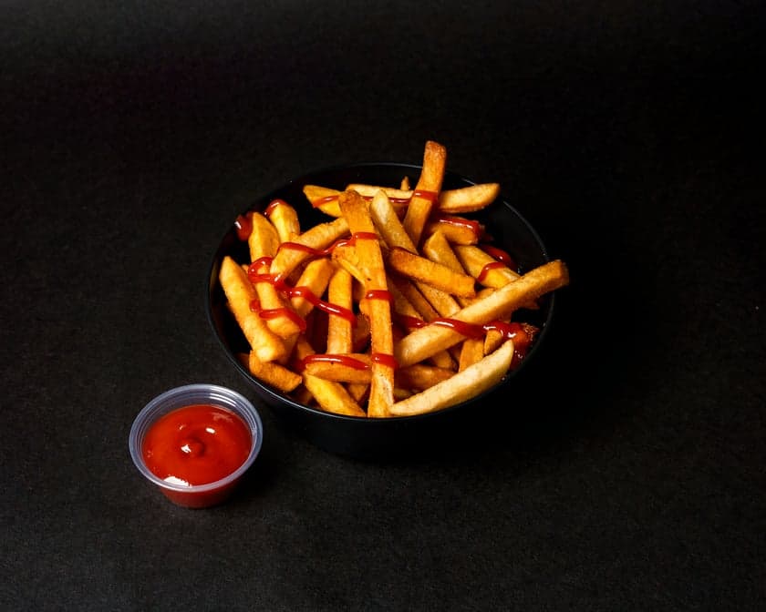 Golden crispy fries with a tub of toum garlic sauce and pink pickled turnips at Patar Shawarma Glendale
