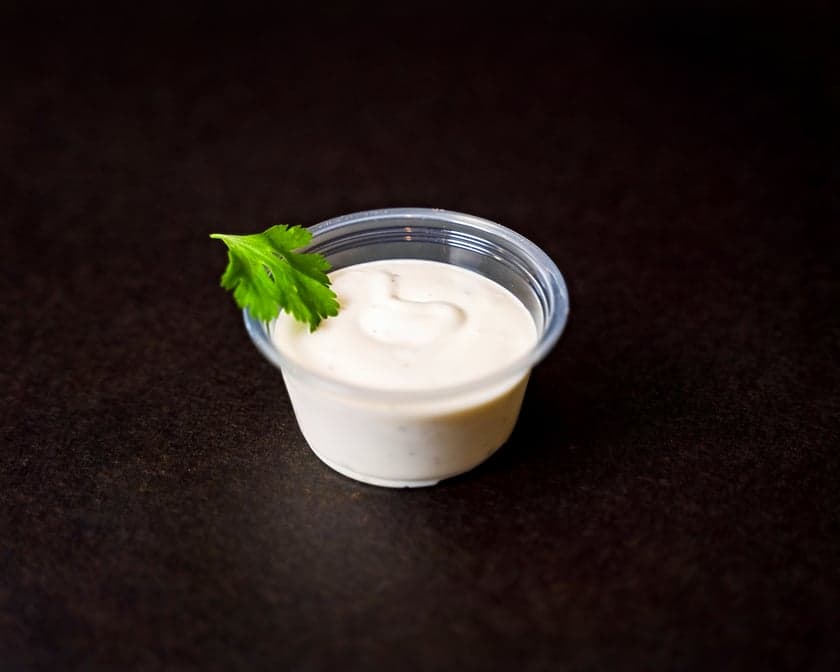 Tub of thick white house-made toum garlic sauce holding stiff peaks, Patar Shawarma Glendale