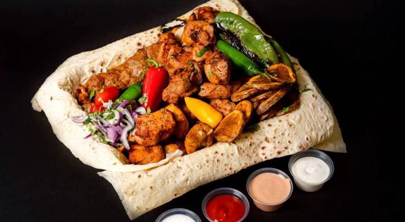 Grilled chicken and beef luleh kebabs over seasoned rice with grilled onion, salad, and lavash at Patar Shawarma Glendale