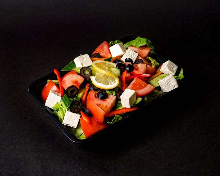 Loaded Greek salad with cucumber, tomato, olives, and feta in a bowl at Patar Shawarma in Glendale
